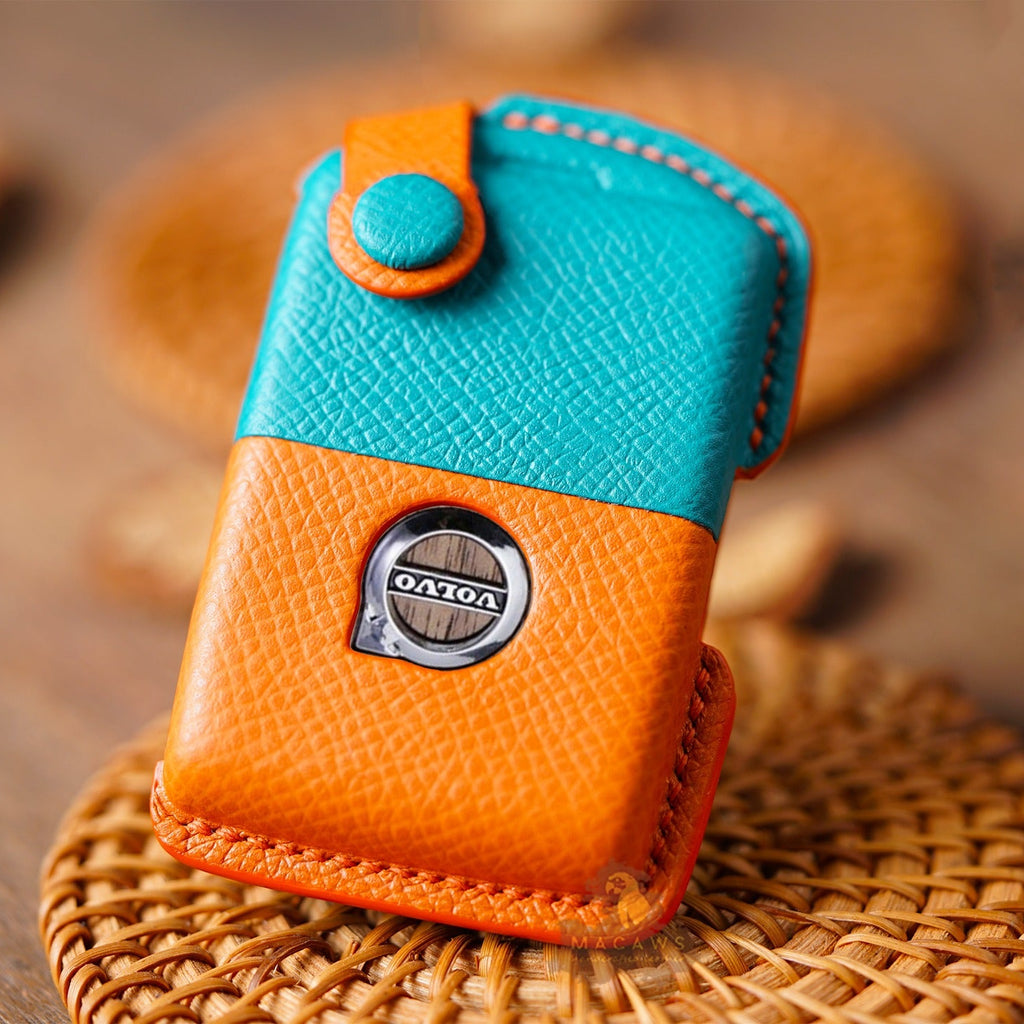 Orange and blue key case with a brand logo on a textured surface