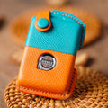 Orange and blue key case with a brand logo on a textured surface